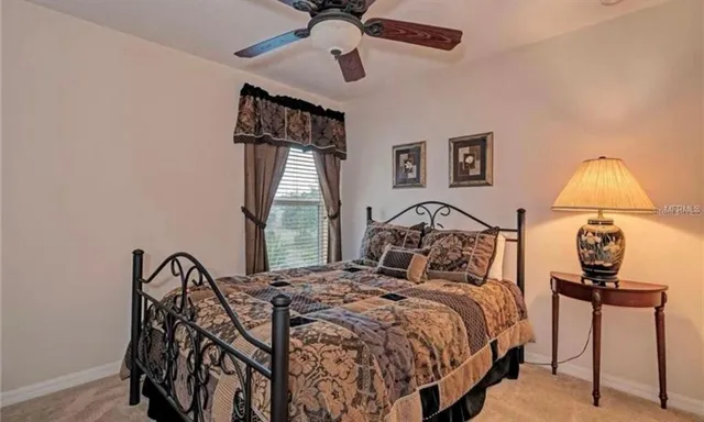 a bed sitting in a bedroom next to a window