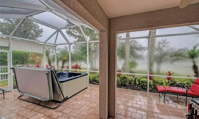 a view of a porch with furniture and garden