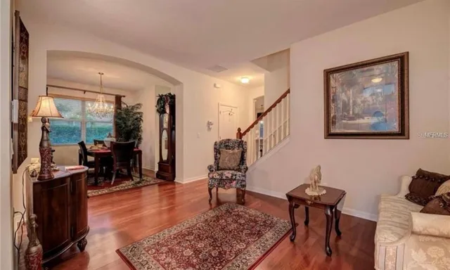 a living room with furniture and wooden floor