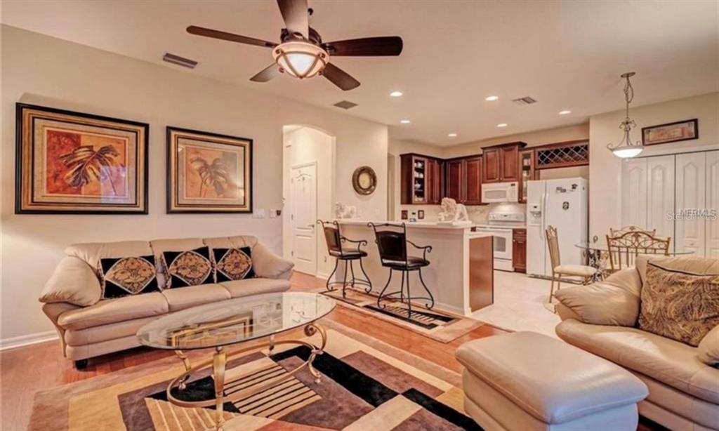 15108 Skip Jack Loop Lakewood Ranch, FL 34202 - Photo 7 of 23 a living room with furniture and kitchen view