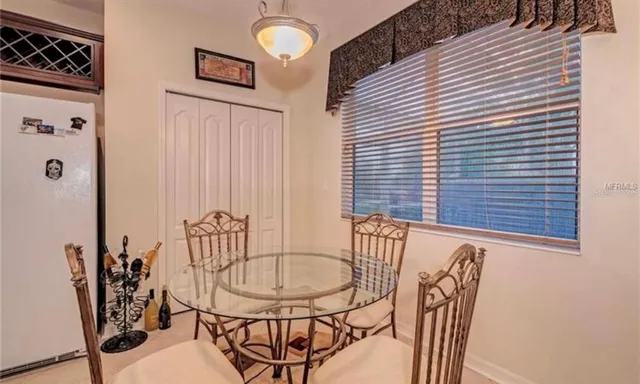 a view of a dining room with furniture and window