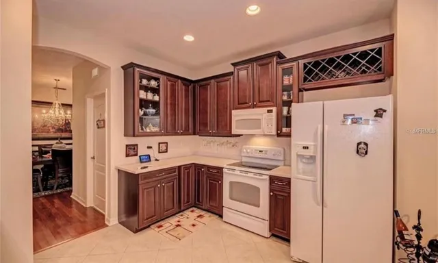 a kitchen with stainless steel appliances granite countertop a refrigerator and a stove top oven