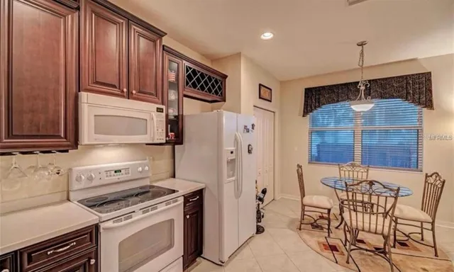 a kitchen with stainless steel appliances granite countertop a stove a refrigerator and a microwave