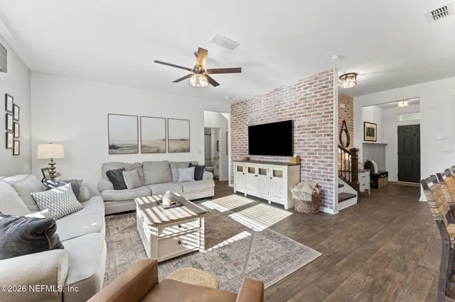 a white toilet sitting next to a small curtain