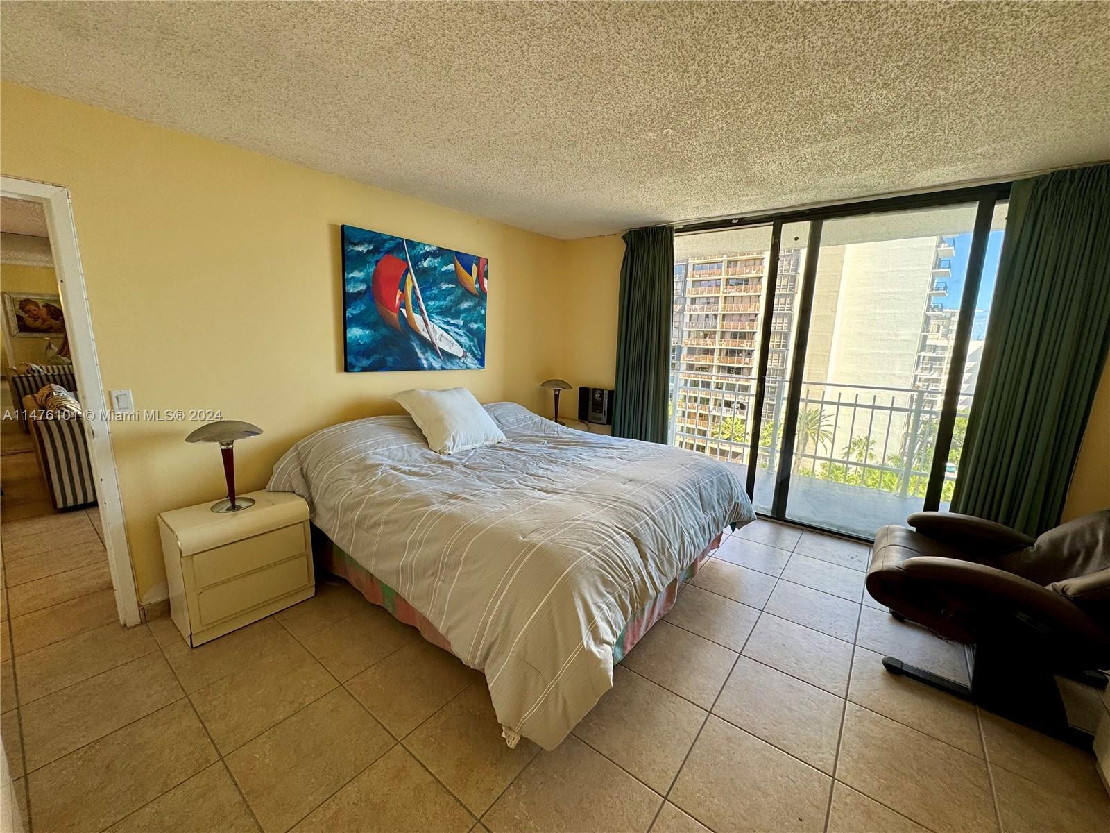 200 Southeast 15th Road, Unit 11F Miami, FL 33129 - Photo 11 of 22 a bedroom with a bed couch and a large window