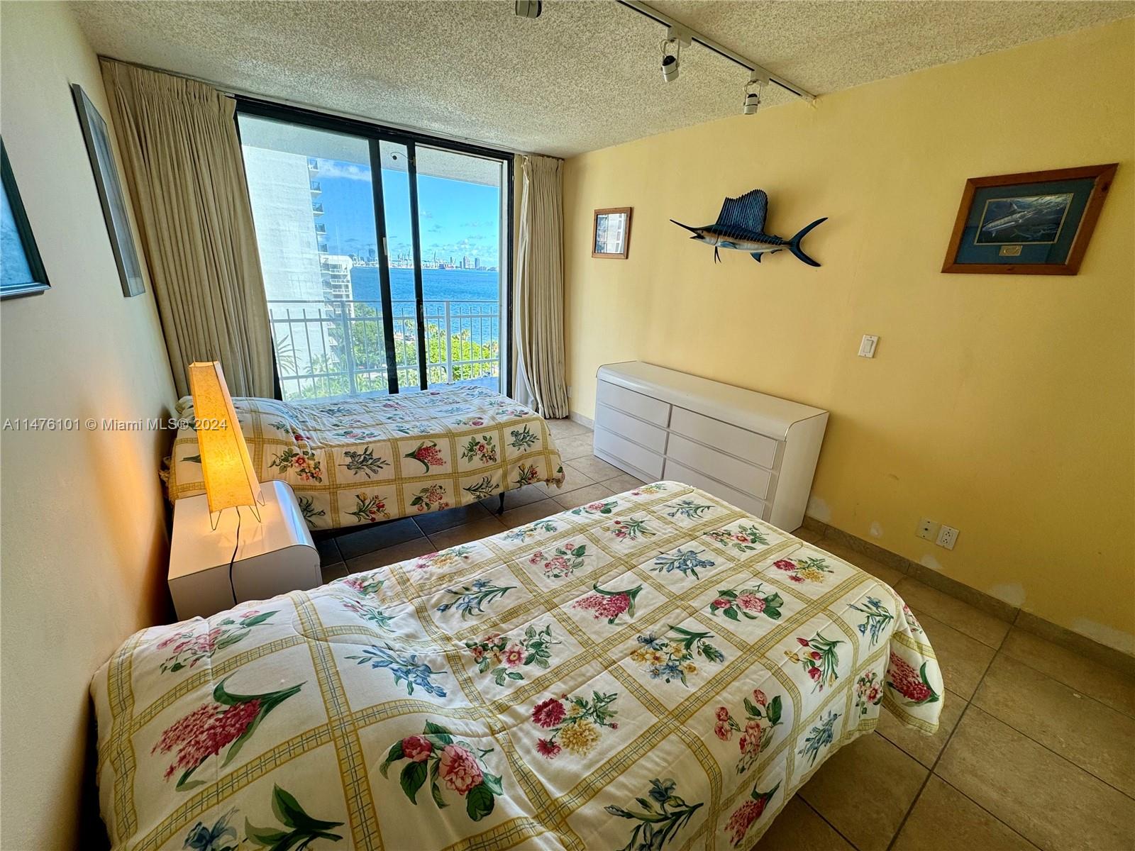 200 Southeast 15th Road, Unit 11F Miami, FL 33129 - Photo 13 of 22 a bedroom with a bed and a window