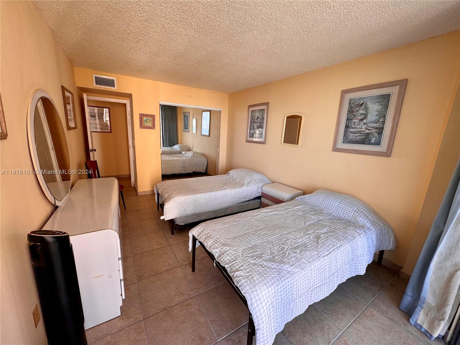 200 Southeast 15th Road, Unit 11F Miami, FL 33129 - Photo 16 of 22 a bedroom with furniture and a wooden floor