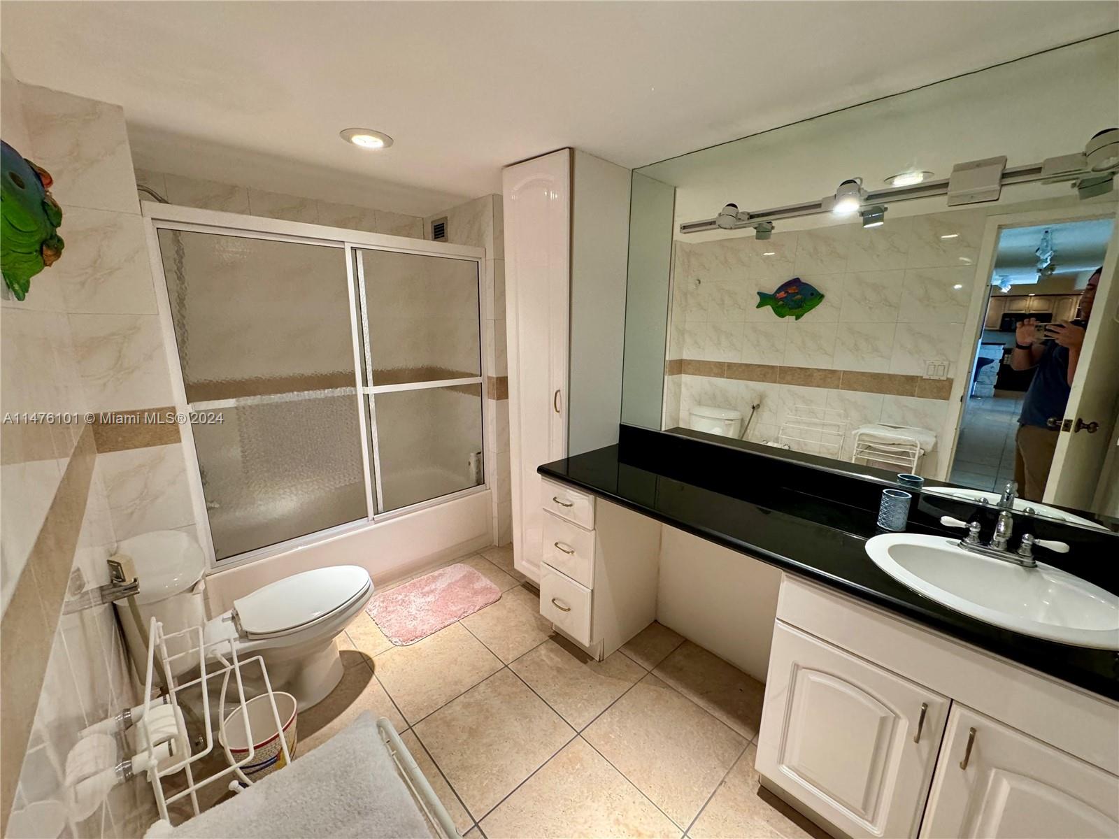 200 Southeast 15th Road, Unit 11F Miami, FL 33129 - Photo 18 of 22 a bathroom with a granite countertop sink toilet and a mirror