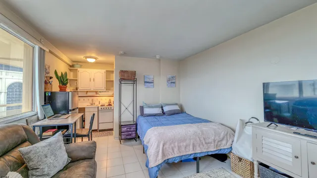 a bedroom with furniture and a bathroom