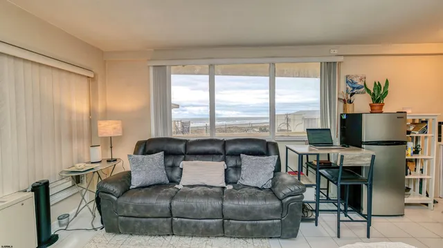 a living room with furniture and large windows