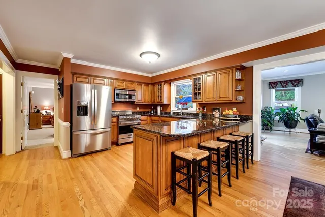 a kitchen with stainless steel appliances granite countertop a stove and cabinets