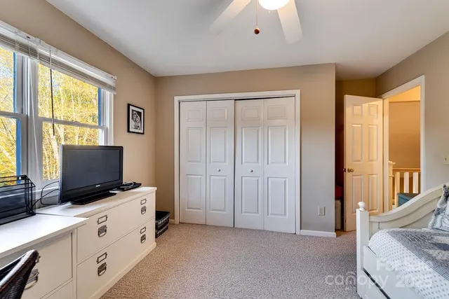 a bathroom with a sink a toilet a mirror and shower curtain
