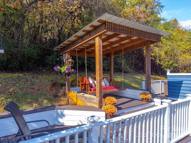 a view of backyard with deck and seating space