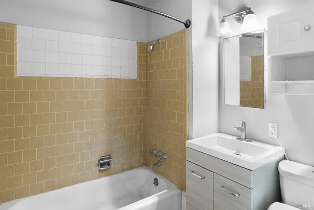 a bathroom with a sink mirror toilet and bathtub