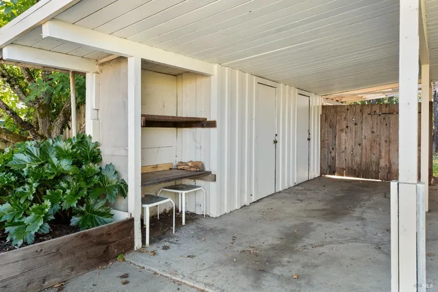 a balcony view with a potted plant in front of it