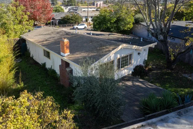 a view of a house with pool and yard