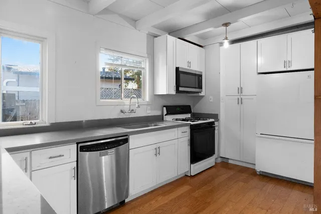 a kitchen with a refrigerator and a sink
