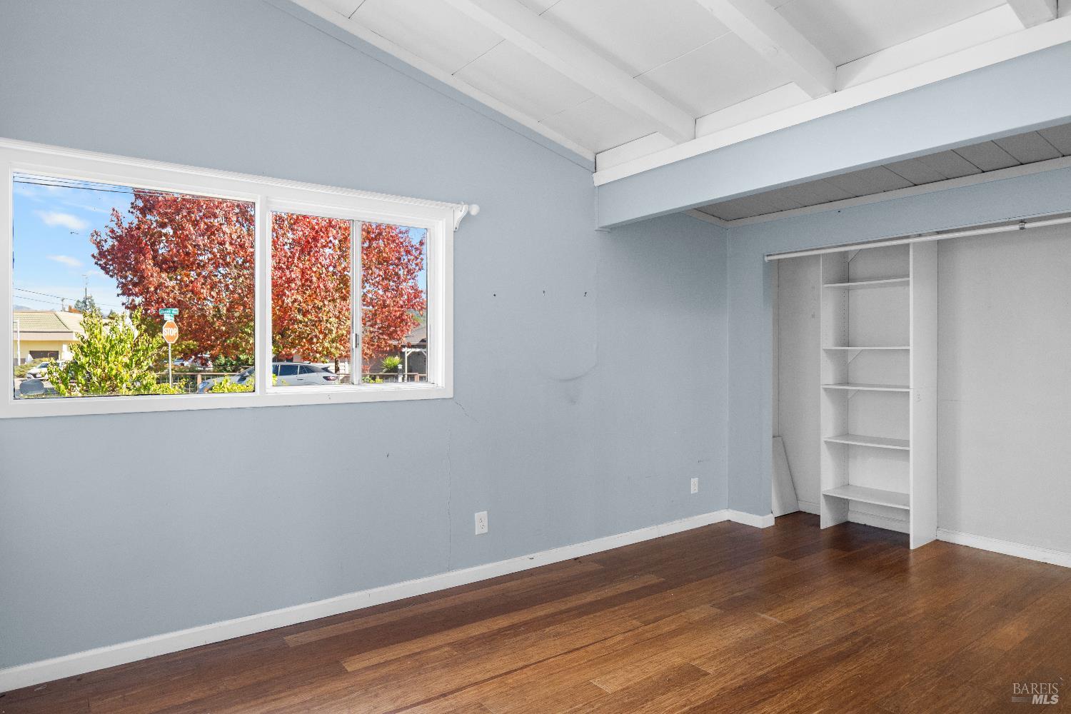 1219 Janet Way Santa Rosa, CA 95405 - Photo 7 of 22 a view of an empty room with wooden floor and a window