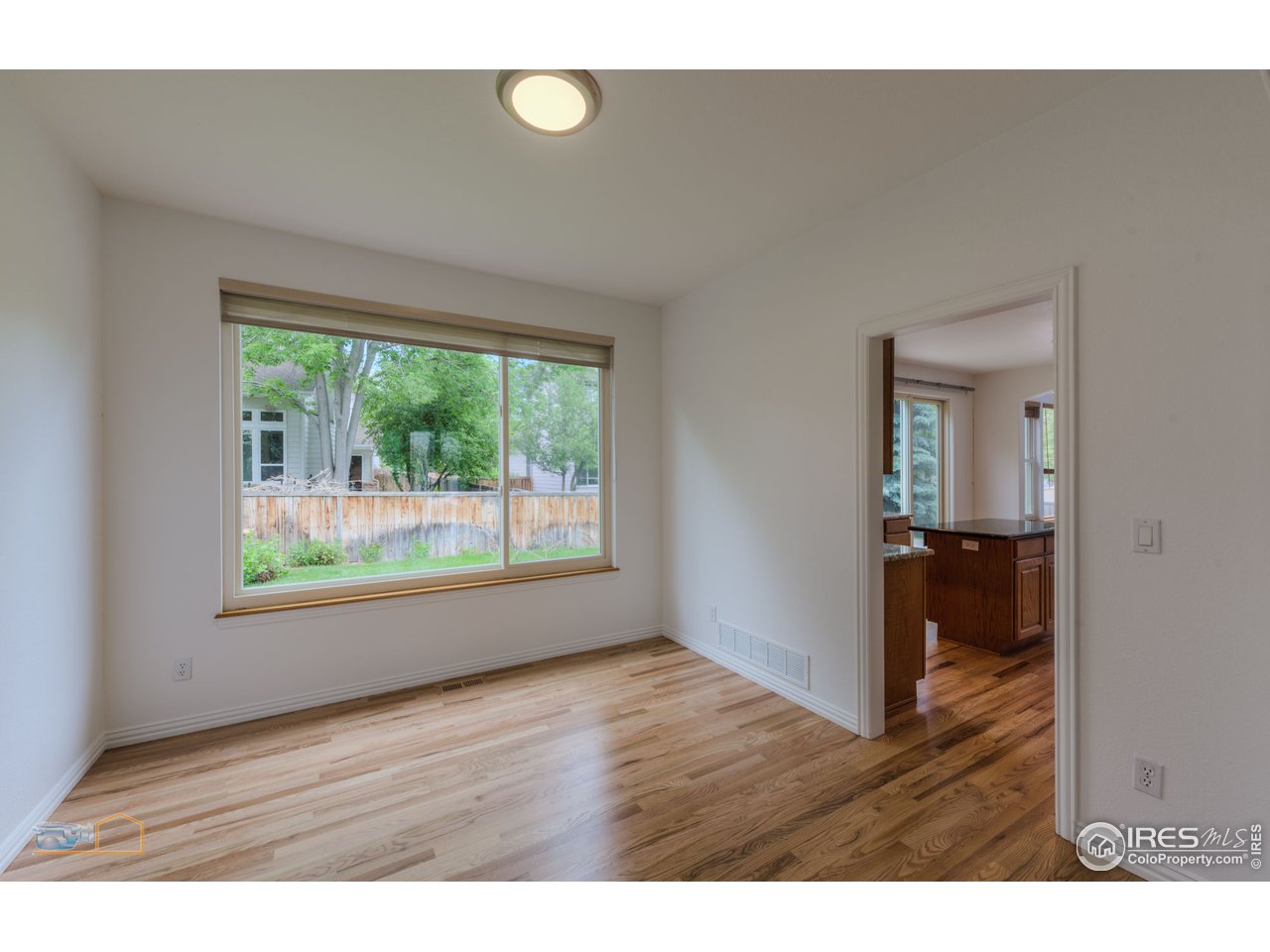 5933 Wellington Road Boulder, CO 80301 - Photo 4 of 39 a view of an empty room with wooden floor and a window
