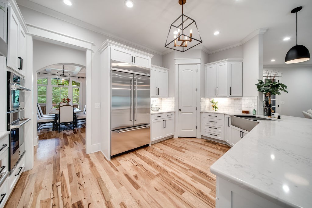 108 Alpine Court Franklin, TN 37069 - Photo 12 of 42 a open kitchen with stainless steel appliances granite countertop a refrigerator and a stove top oven
