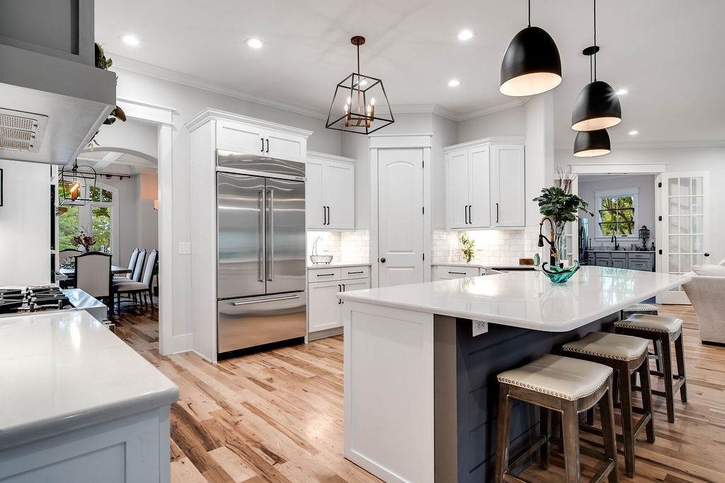 108 Alpine Court Franklin, TN 37069 - Photo 16 of 42 a kitchen with kitchen island a dining table chairs stainless steel appliances and cabinets