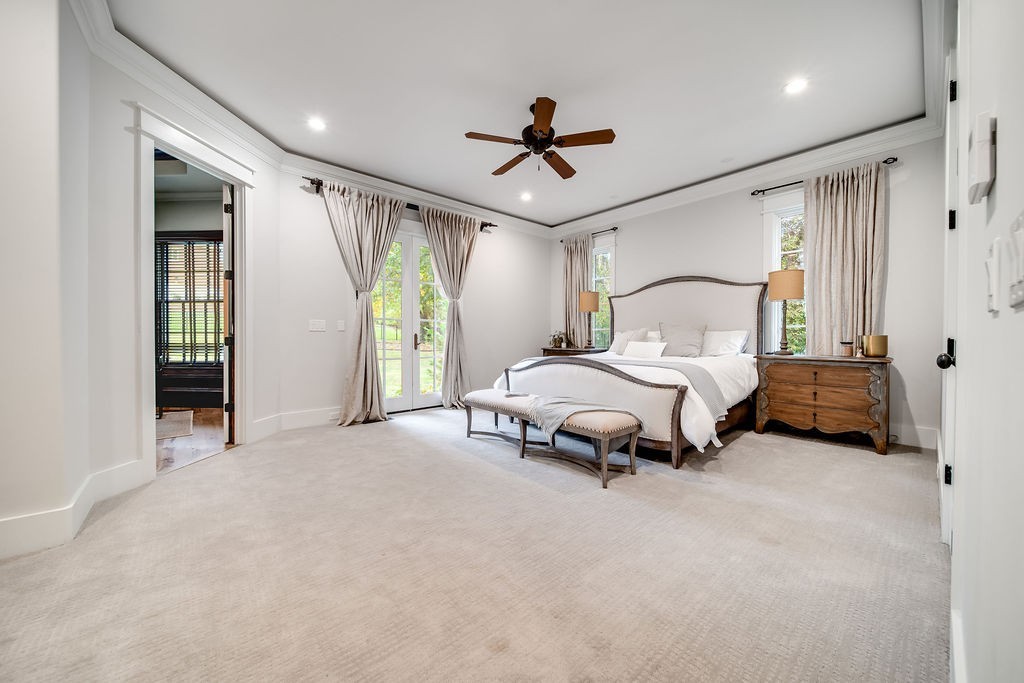 108 Alpine Court Franklin, TN 37069 - Photo 21 of 42 a spacious bedroom with a bed and a chandelier