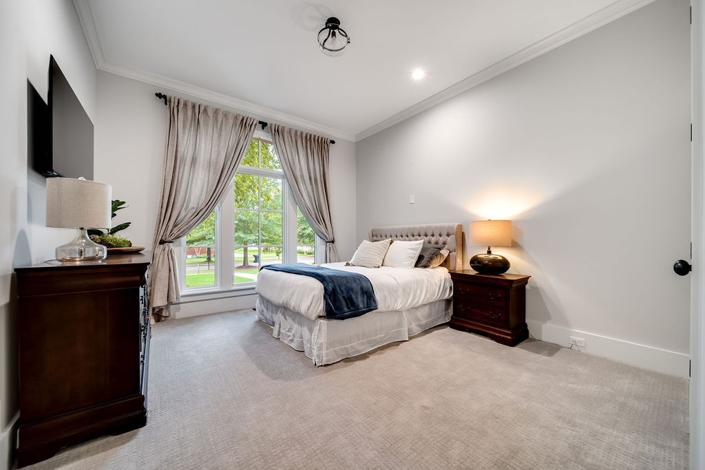 108 Alpine Court Franklin, TN 37069 - Photo 33 of 42 a bedroom with a bed and a flat tv screen on dresser