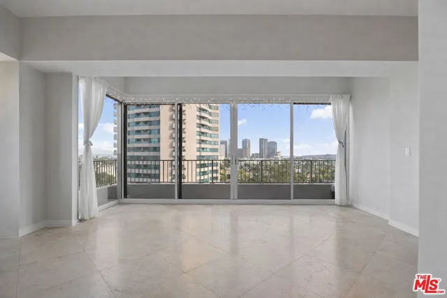 a view of an empty room with windows