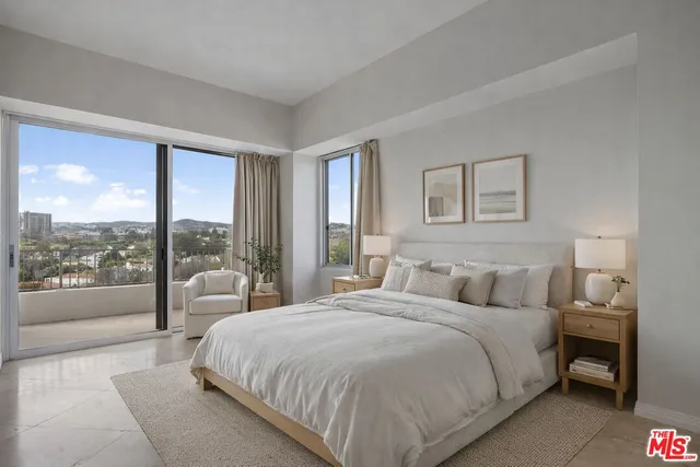 a bedroom with a large bed and a large window