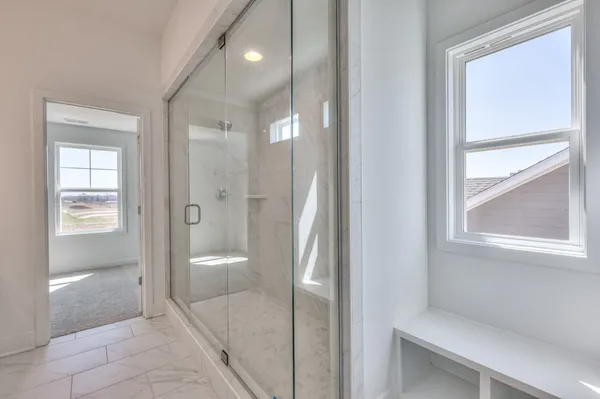 a bathroom with a glass shower door and a bathroom