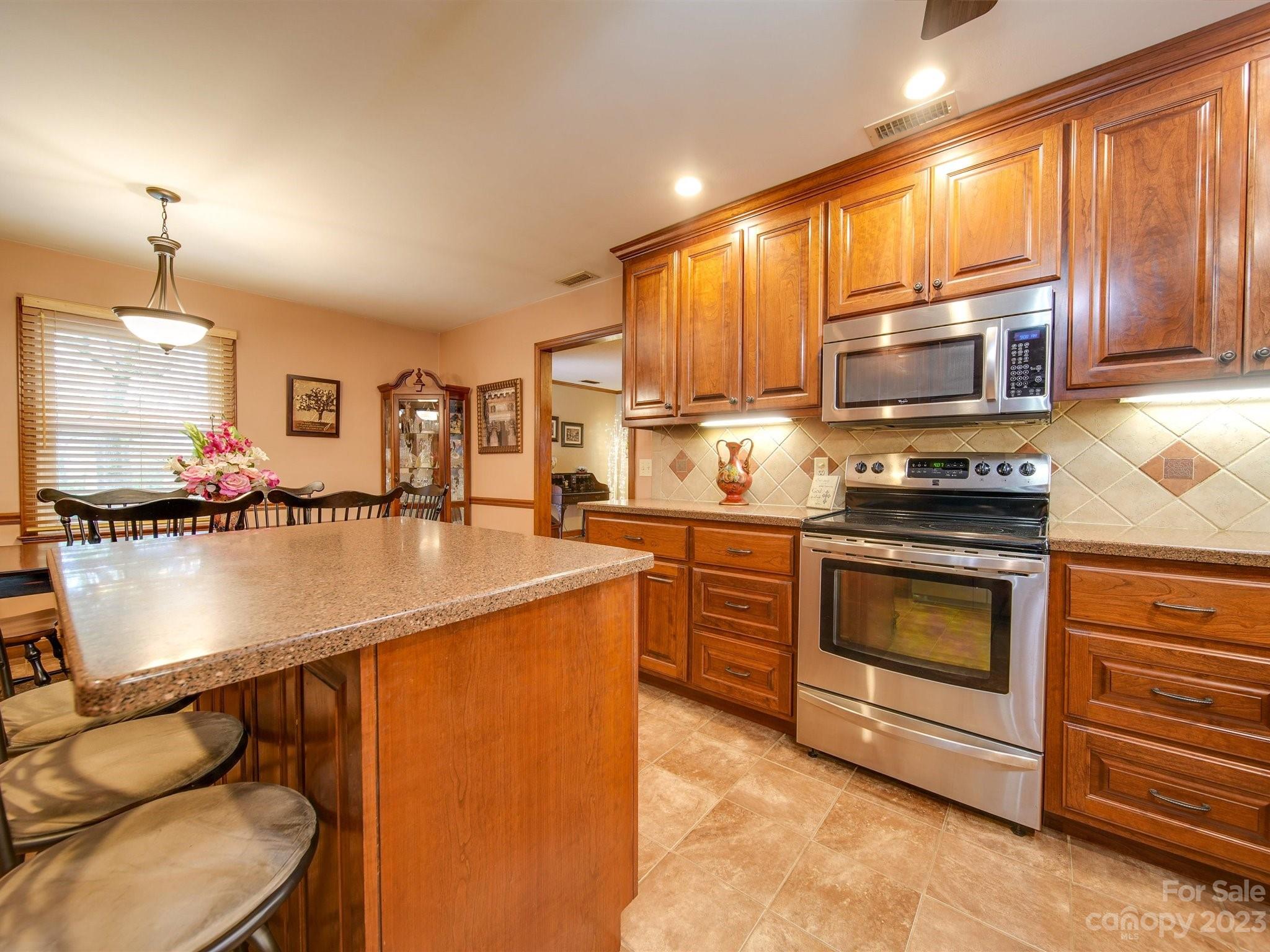 3403 Stack Road Monroe, NC 28112 - Photo 14 of 31 a kitchen with stainless steel appliances granite countertop a stove a sink and a microwave