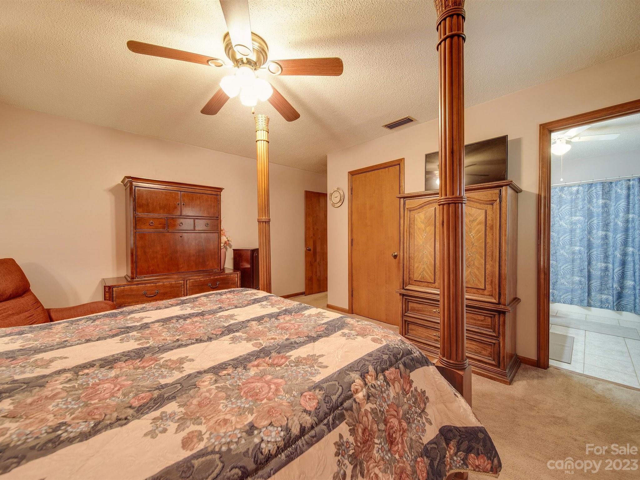 3403 Stack Road Monroe, NC 28112 - Photo 18 of 31 a bedroom with a bed and a chandelier