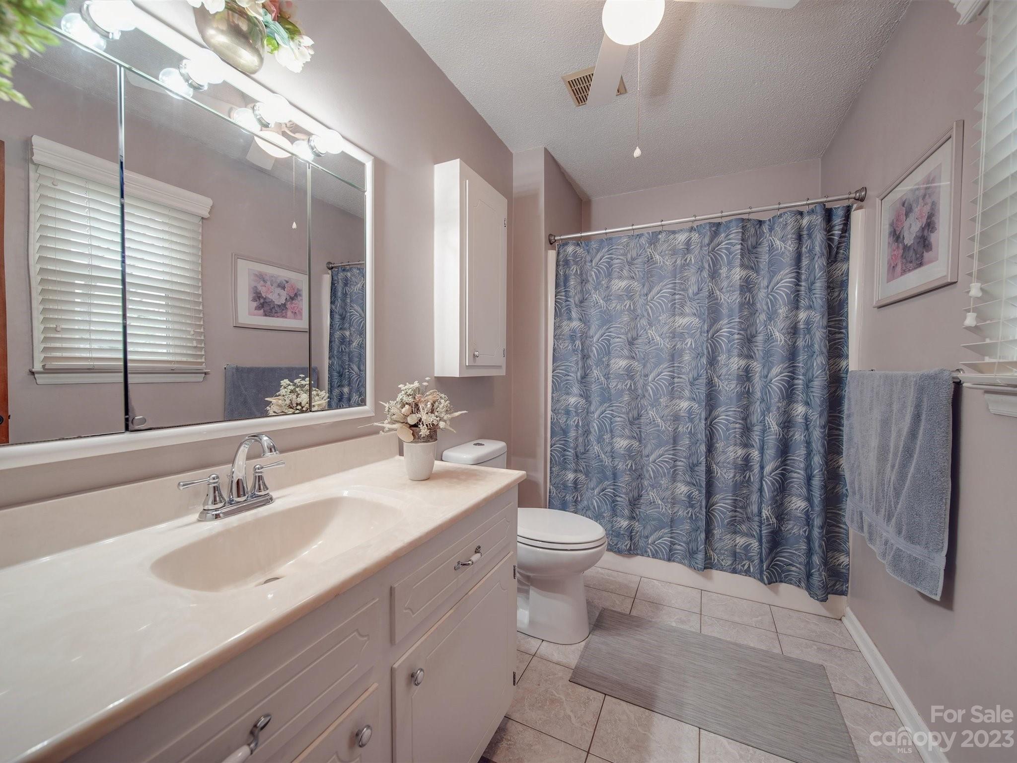 3403 Stack Road Monroe, NC 28112 - Photo 19 of 31 a bathroom with double vanity sink a toilet a mirror and shower