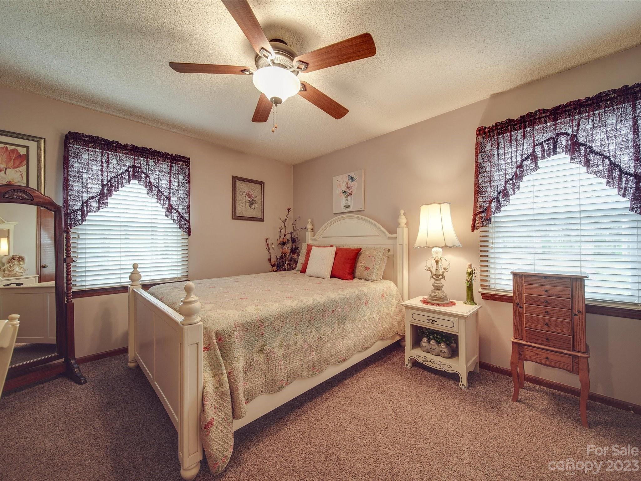 3403 Stack Road Monroe, NC 28112 - Photo 20 of 31 a bedroom with a bed and a chandelier
