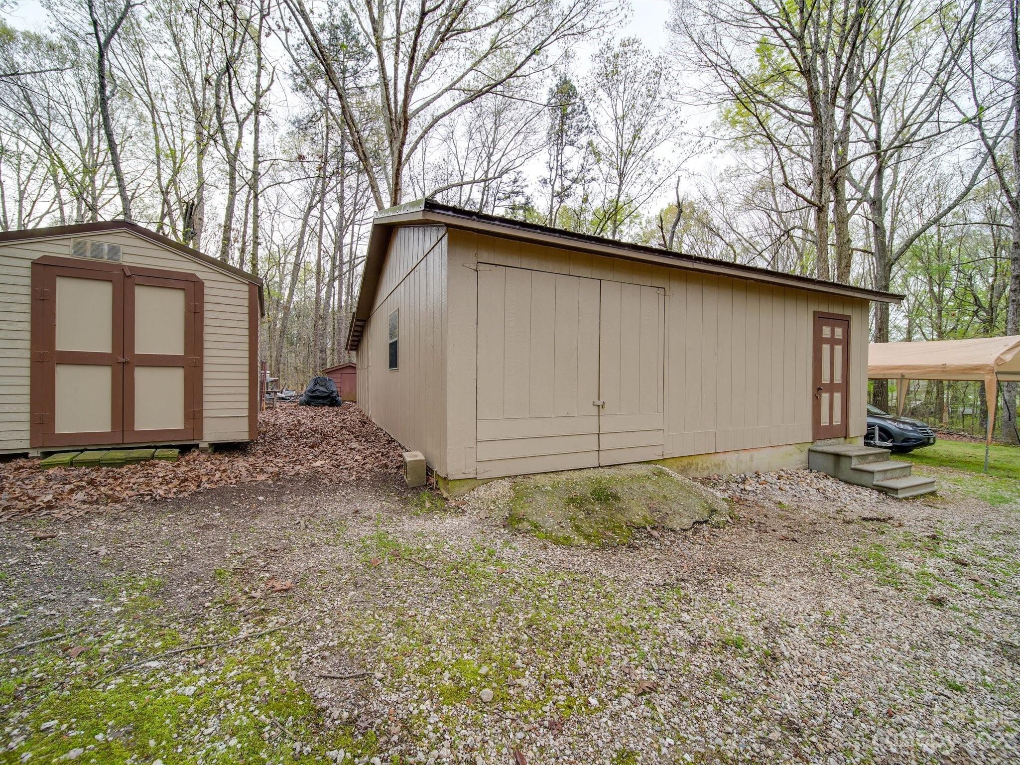 3403 Stack Road Monroe, NC 28112 - Photo 26 of 31 a backyard of a house with large trees and wooden fence