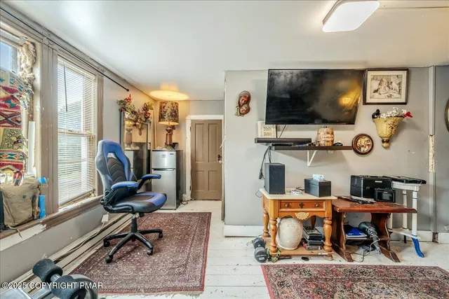 a living room with furniture and a clock