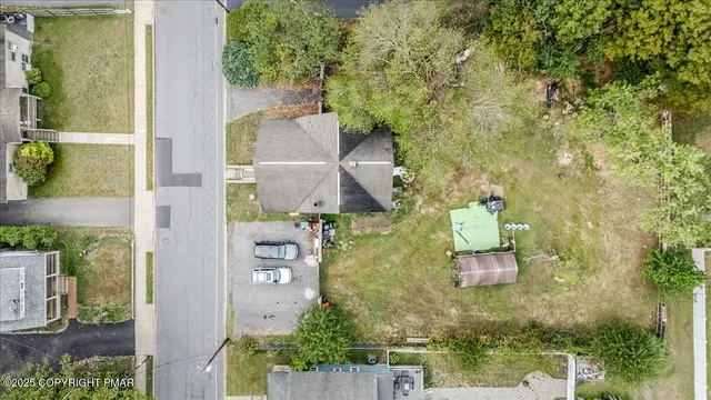 an aerial view of a house with outdoor space
