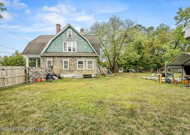 a front view of a house with yard and green space