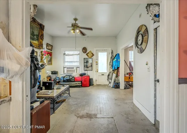 a view of a livingroom with furniture and a fan