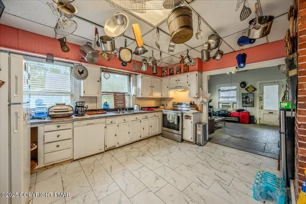 a kitchen with stainless steel appliances granite countertop a sink and cabinets