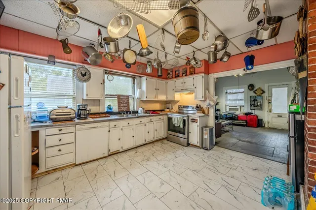 a kitchen with stainless steel appliances granite countertop a sink and cabinets