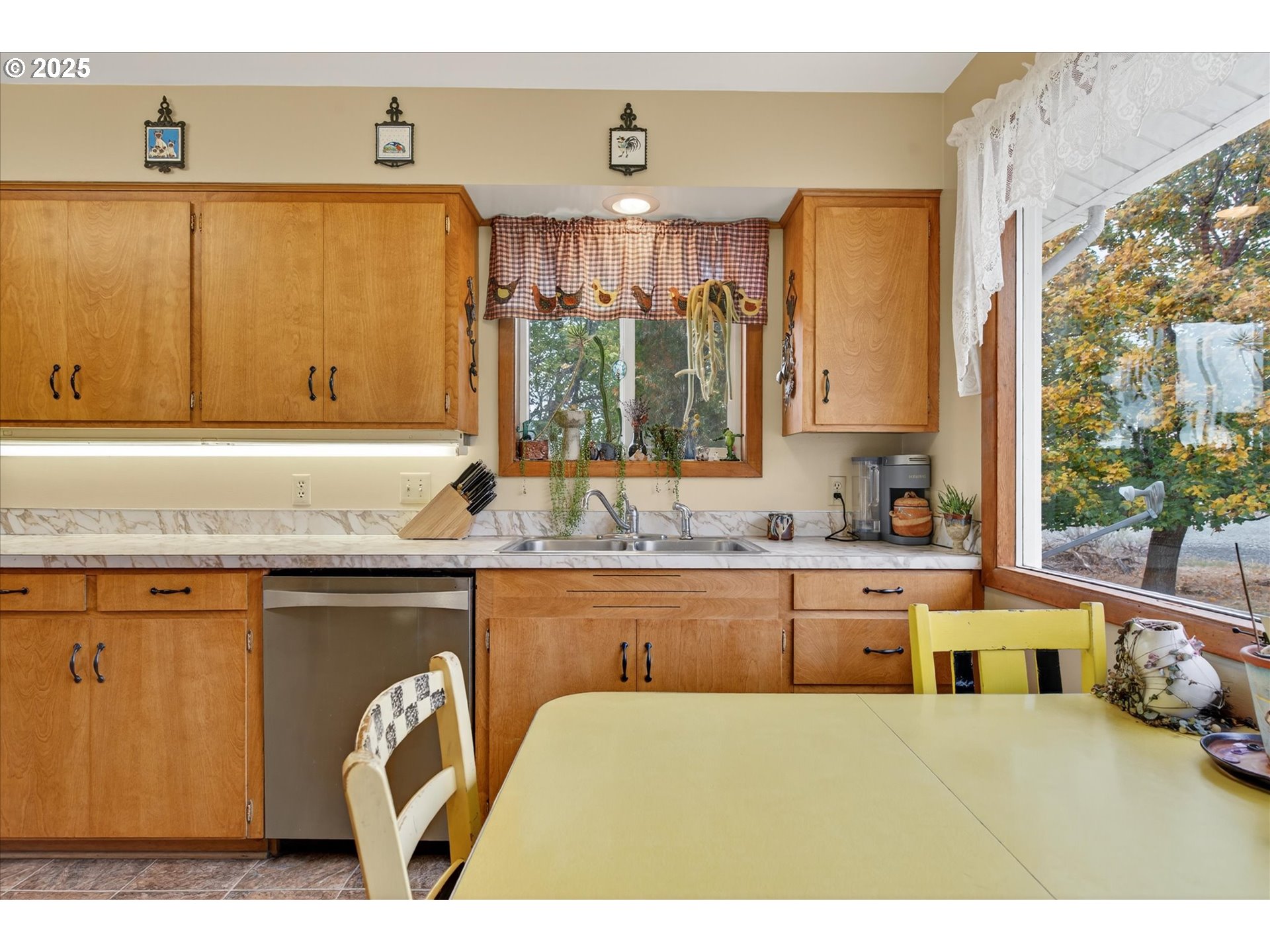 1025 17th Street Baker City, OR 97814 - Photo 24 of 48 a kitchen with stainless steel appliances wooden cabinets a sink and a large window