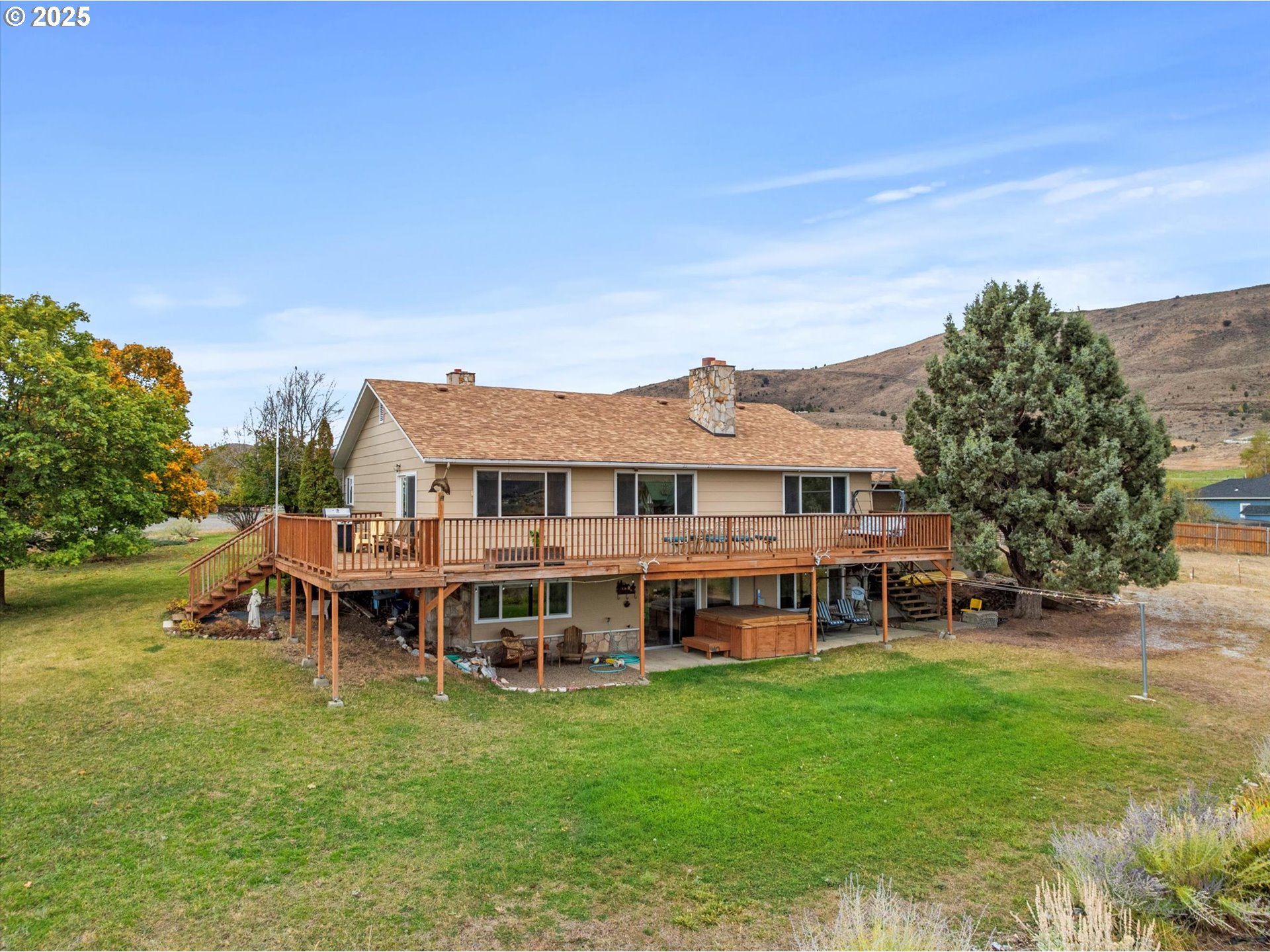 1025 17th Street Baker City, OR 97814 - Photo 3 of 48 a view of a house with a yard table and chairs