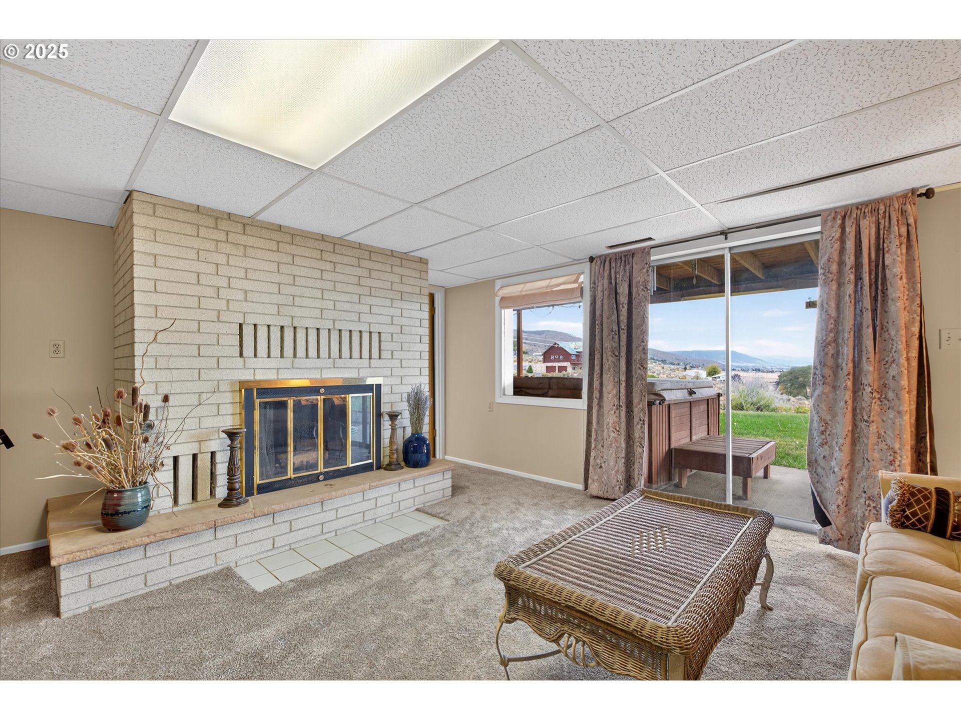 1025 17th Street Baker City, OR 97814 - Photo 36 of 48 a living room with furniture a window and a fireplace