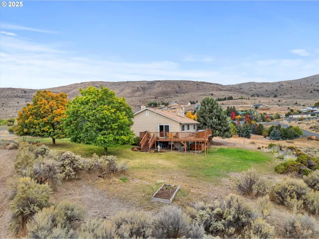 a view of a balcony with wooden floor and seating space