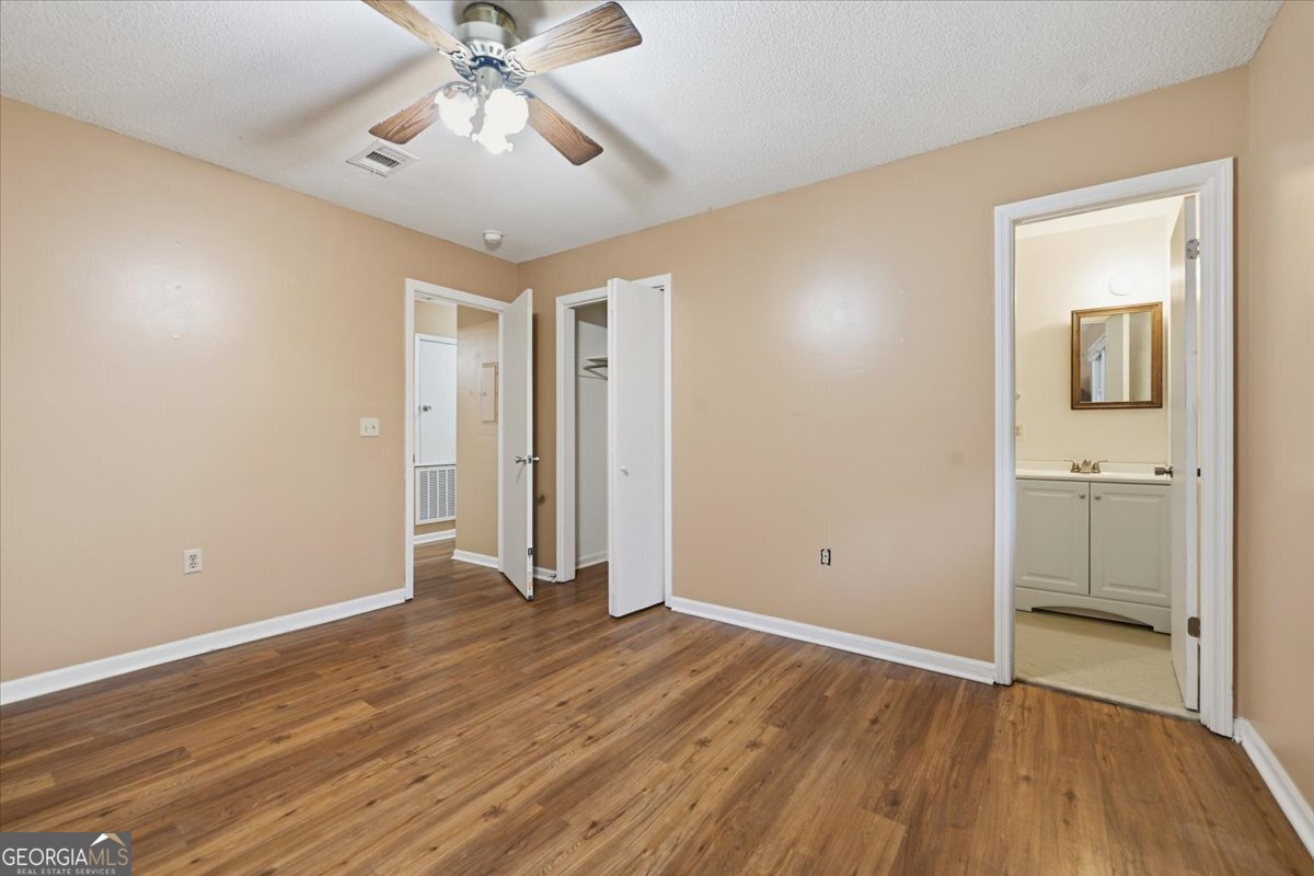223 Randy Circle Warner Robins, GA 31088 - Photo 18 of 27 a view of a room with wooden floor and a ceiling fan