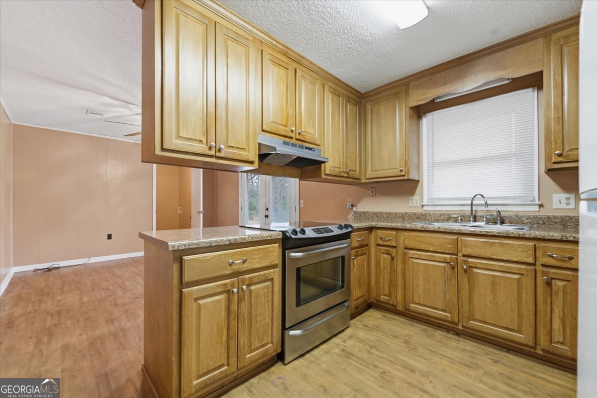 223 Randy Circle Warner Robins, GA 31088 - Photo 7 of 27 a kitchen with stainless steel appliances granite countertop a sink and a stove next to a window