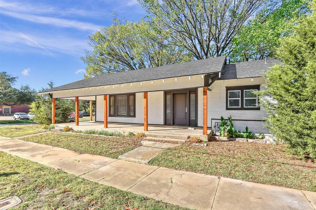 1115 South Rusk Avenue Denison, TX 75020 - Photo 3 of 21 a front view of a house with a yard and potted plants