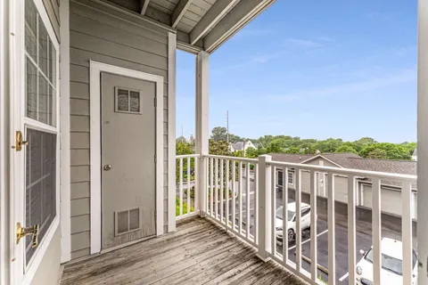 a view of a balcony with wooden floor