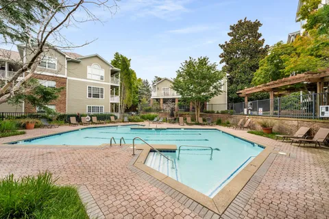 a view of a house with pool and sitting area
